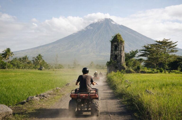 An ATV riding a dirt track through rice paddies near the Cagsawa Ruins